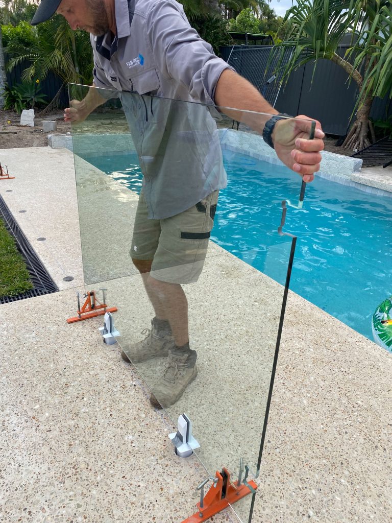 Luke Anstiss installing glass pool fencing using GlassMate install tool